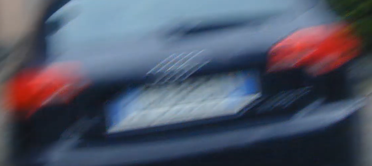 Rear of a moving sedan — original